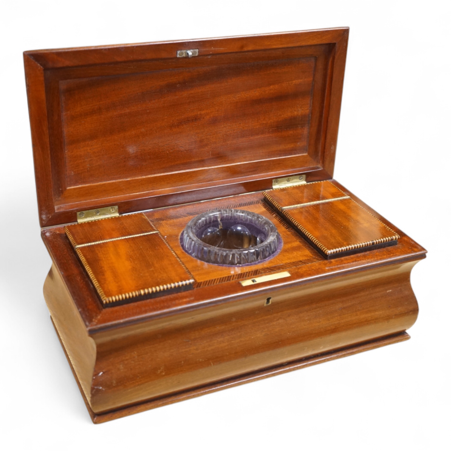 A 19th century mahogany sarcophagus tea caddy, with interior fittings, 35cm wide x 15.5cm high